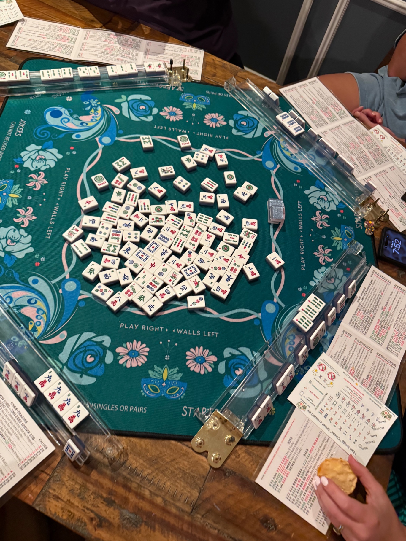 A player studying her card between turns